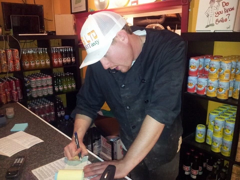 Early days of founder Aaron Gehrman taking a phone order in a receipt book at his first established location in White Rock.